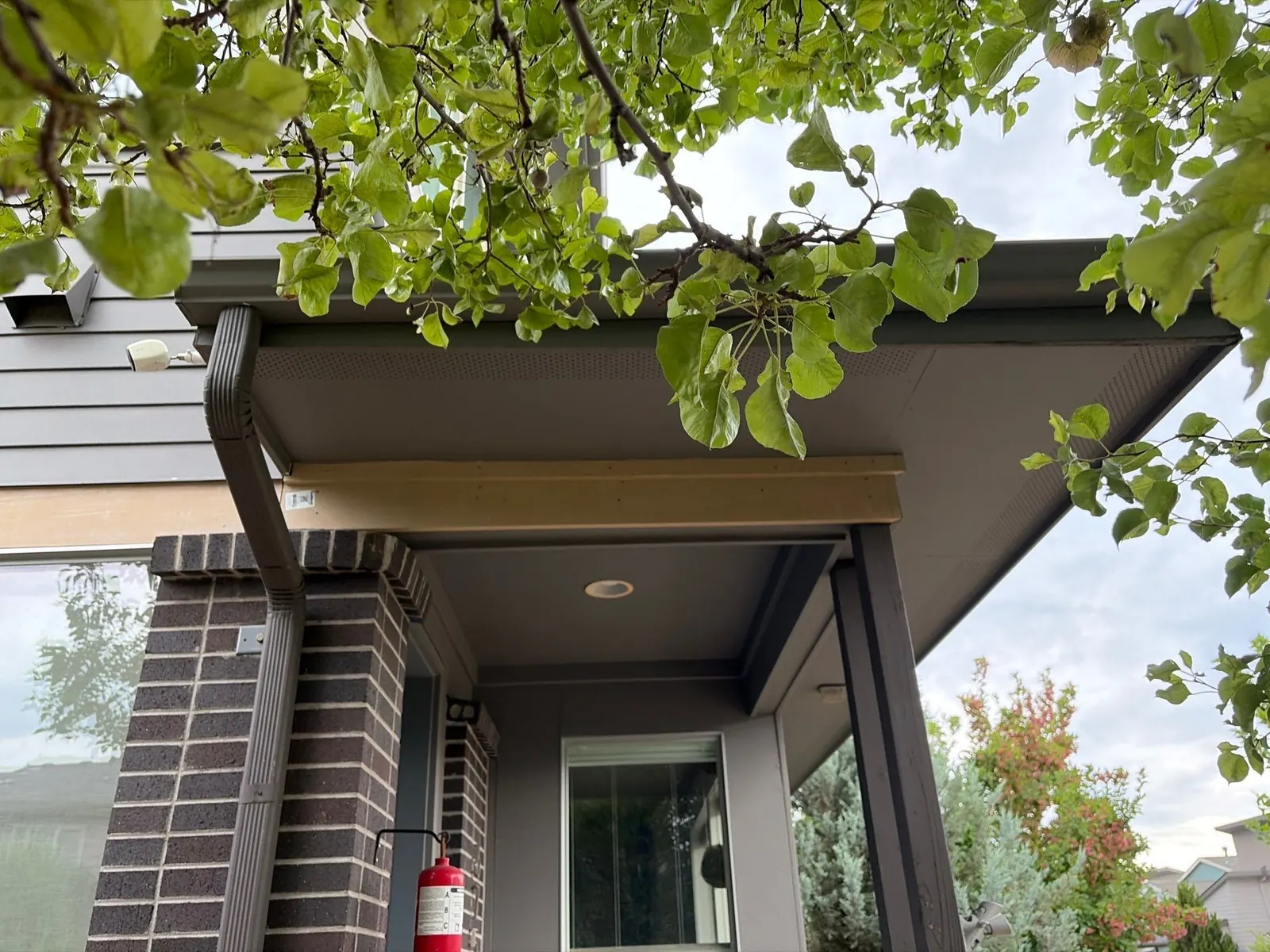 Freshly replaced wood fascia board under the eaves during exterior repair prep